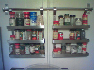two hanging metal racks filled with various spices
