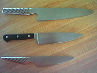 three knives, one 8 in. long, one 6 in. chef's, one 4 in. chopper
