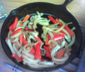 onions and red peppers in a skillet