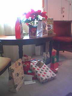 presents around a poinsettia on a table